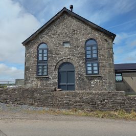 Small chapel with two round-headed windows, converted to residential
